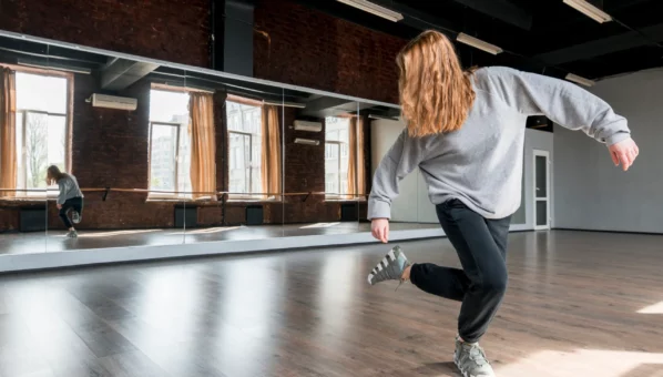 blonde-young-woman-dancing-against-mirror-dance-studio